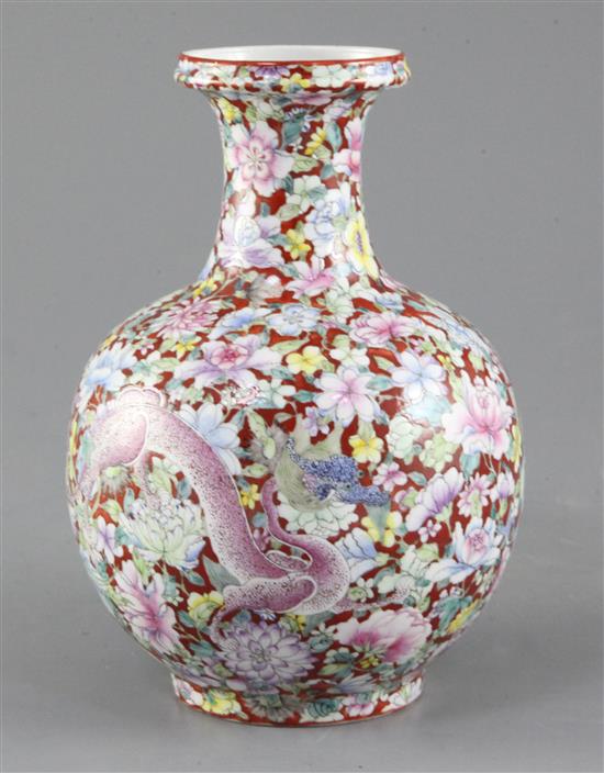 A Chinese coral ground dragon bottle vase, Qianlong seal mark, early 20th century, 19cm